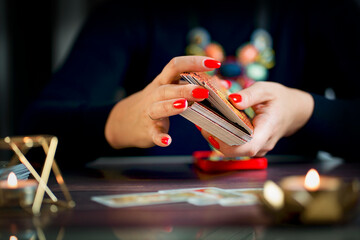 Selective Focus of two hands shuffling and adjusting tarot cards