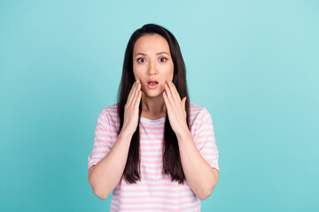 Photo of shocked surprised mixed race mestizo lady dressed striped t-shirt hands cheeks isolated teal color background