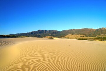 large sand dune of Valdevaqueros in front of green mountains of Andalusia during the sunset, Tarifa, Costa de la Luz, Andalusia, province of Cádiz, Spain, Travel, Tourism