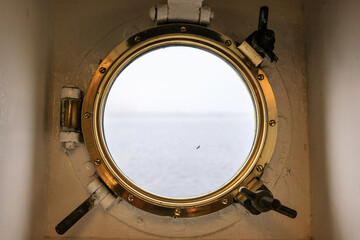  A Glimpse of the Calm Sea Through a Ship’s Porthole