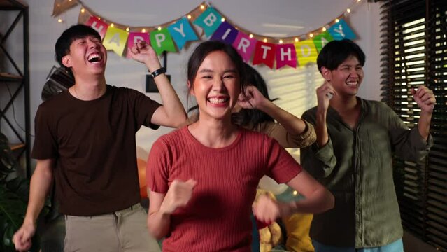 Group of young women celebrating their friend forthcoming marriage, young asian female happy smiling and dancing with friends in birthday party at home
