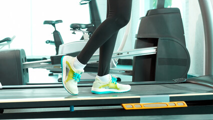 Close up Foot and leg Fitness Asian woman standing and resting on treadmill, marathon races...