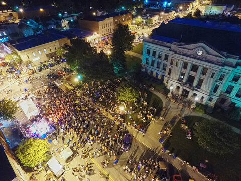 Aerial Urban Festival at Night with Historic Courthouse Background