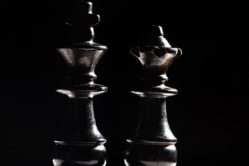 Chess pieces,beautiful old chess pieces on a board, black background, selective focus.