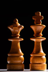 Chess pieces,beautiful old chess pieces on a board, black background, selective focus.