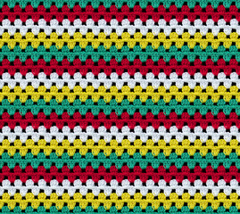 Bright seamless knitted texture. The pattern is crocheted from multi-colored cotton yarn. Zigzag...