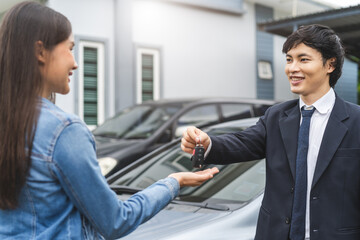 transportation rental automotive business concept. Close up hands of rental auto agent giving car...
