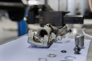 Close-up of the car starter on the table in the car repair shop. Car repair.