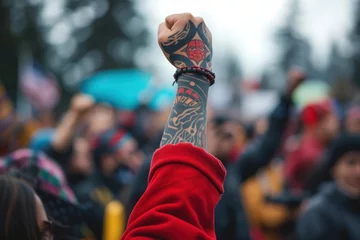 Foto op Canvas A political rally or protest led by Indigenous activists. showing their arm up high, tattoo, Native American, Indigenous concept. protesting for their rights and the protection of their land © Gasi