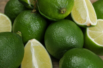 Pile of fresh limes and leaves, closeup