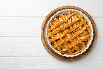 Tasty homemade quince pie on white wooden table, top view. Space for text