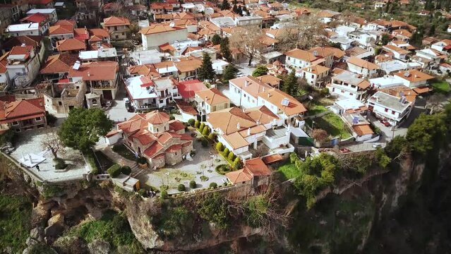 Drone shot of the Church of the Dormition of the Virgin and the nearby buildings in Tithorea, Greece