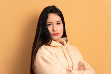serious young brunette woman looking at camera in studio shot. portrait, real people concept.