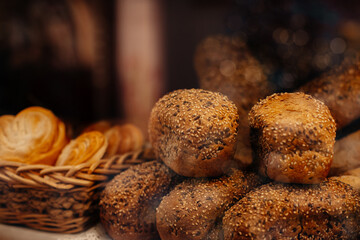 Fresh baked multigrain bread in a wicker basket in a baked goods store