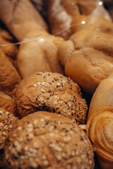 Fresh baked multigrain bread in a wicker basket in a baked goods store