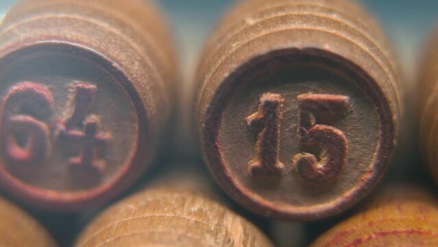 Cinematic macro smooth shot of Bingo wooden barrels in a row, woody figures, old numbers vintage board game, number 15, slow motion, commercial gimbal movement, pan right