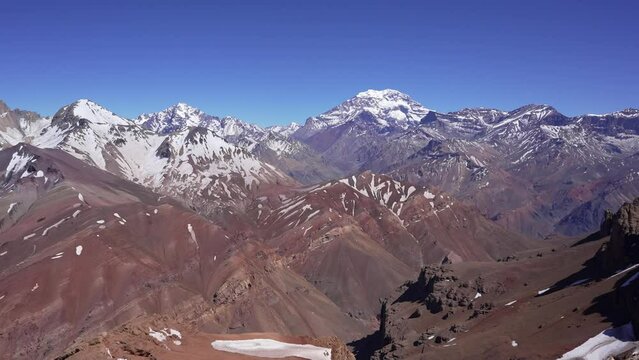 view of the andes mountains near the summit of cerro penitentes in mendoza. South face of Aconcagua on a clear blue saky