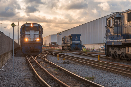 City of Santos, Brazil. Locomotives from the company Rumo Log&iacute;stica on the Porto de Santos railroad in front of the Bracell Celulose warehouse.