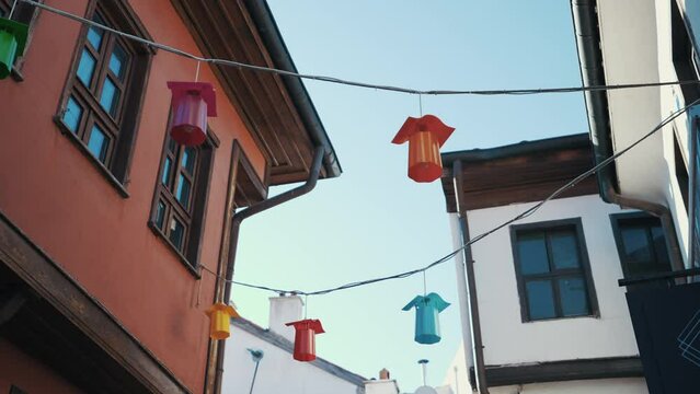 The camera moves down a street with colorful houses with bay windows. Eskişehir, Odunpazarı