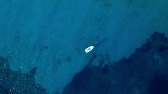 Skyview of a sailboat in Blue Lagoon, Punta Molentis Beach, Villasimius, South Sardinia, Italy