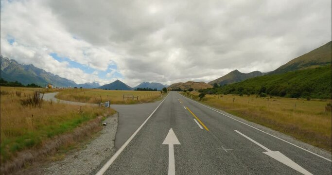 Traveling On Asphalt Highway To Glenorchy In Otago Region, New Zealand. wide shot