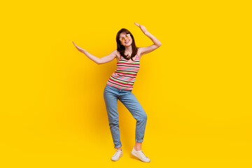 Fototapeta na wymiar Full size photo of pleasant woman dressed knitwear top jeans pants in sunglass hands up dancing isolated on yellow color background