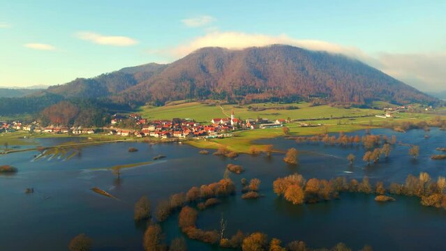 Aerial 4K drone footage of a  Planina plain (Planinsko polje), Slovenia. It was filmed during a rare flooding event. The video shows fields, roads and trees that are surrounded by sheer water.