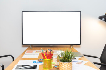 A blank white TV sits on a table in a meeting room. The room is clean and tidy, with no people or...