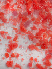 Scattered popping candy, close up on white