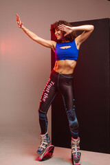 Sporty woman with curly hair in Kangoo jumpers on studio background - 718041312