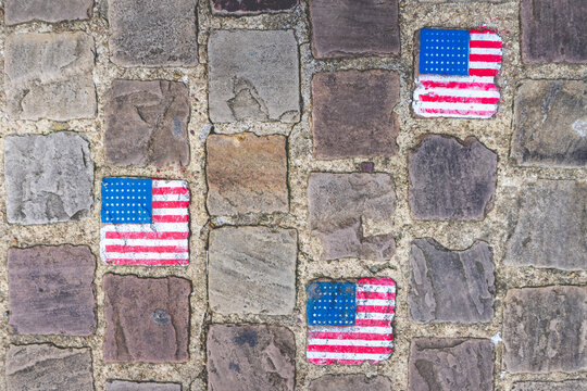 Cable stones painted with the American flag in Carentan France.