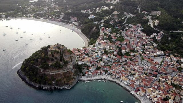 Panoramic drone shot of Parga town breathtaking natural landscape and traditional architecture at sunset, Greece