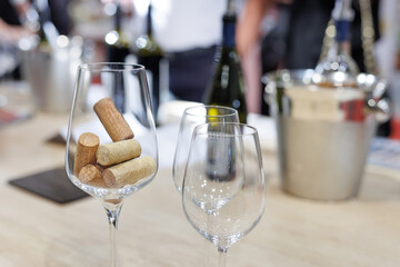A wine glass full of wine corks on the table during a wine tasting.