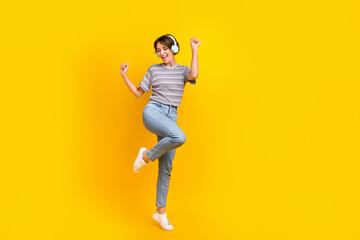 Fototapeta na wymiar Full body photo of cheerful carefree lady dancing listen music headphones empty space isolated on yellow color background