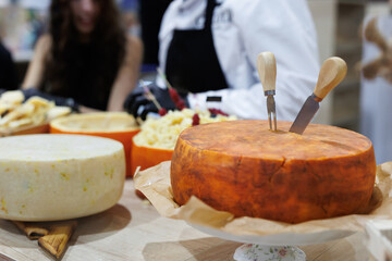 Large handmade cheese heads at a farmer's fair.