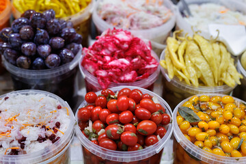 A large selection of various canned vegetables at the farmer's market.