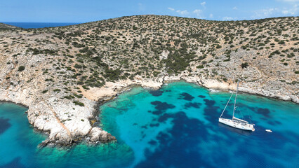 Aerial drone photo of sail boat anchored in paradise bay of Naousa with emerald crystal clear sea,...