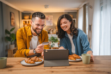 adult happy couple man and woman shopping online hold credit card