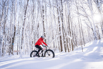 Fat biker riding his bicycle in the snow during Canadian winter