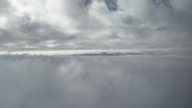 Airplane Passenger POV Flying Between Two Layers Of Clouds.
