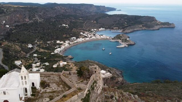 Travelling Aerial Shot Moving Away from Kapsali Bay Revealing Chora Castle Church, Greece