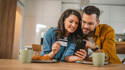 adult happy couple man and woman shopping online hold credit card - obrazy, fototapety, plakaty