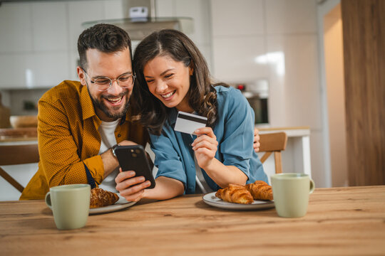 adult happy couple man and woman shopping online hold credit card