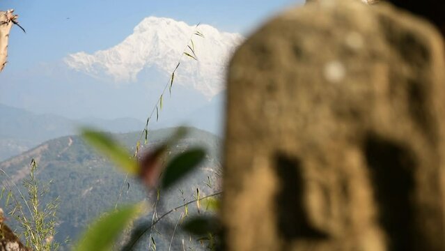 refocus from stone carving to annapurna from pokhara hills