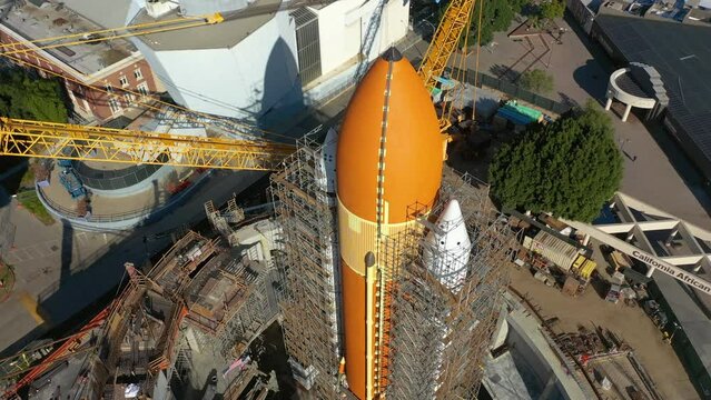 Drone shot tilting around a large space rocket, in sunny United states of America