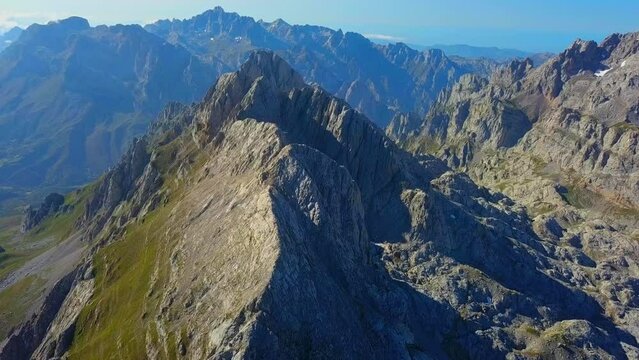 Elegance: Rugged elegance defines Picos de Europa as the drone glides above, unveiling the sheer beauty of nature's fortress. Granite peaks stand sentinel, creating an atmosphere of timeless serenity.