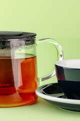 tea set from a teapot and mug on a colored background