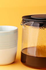 tea set from a teapot and mug on a colored background