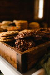 Assortment of cookies in rustic wooden box on a dark background