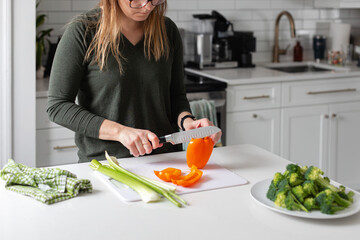woman chopping vegetables for vegetarian healthy dinner - obrazy, fototapety, plakaty